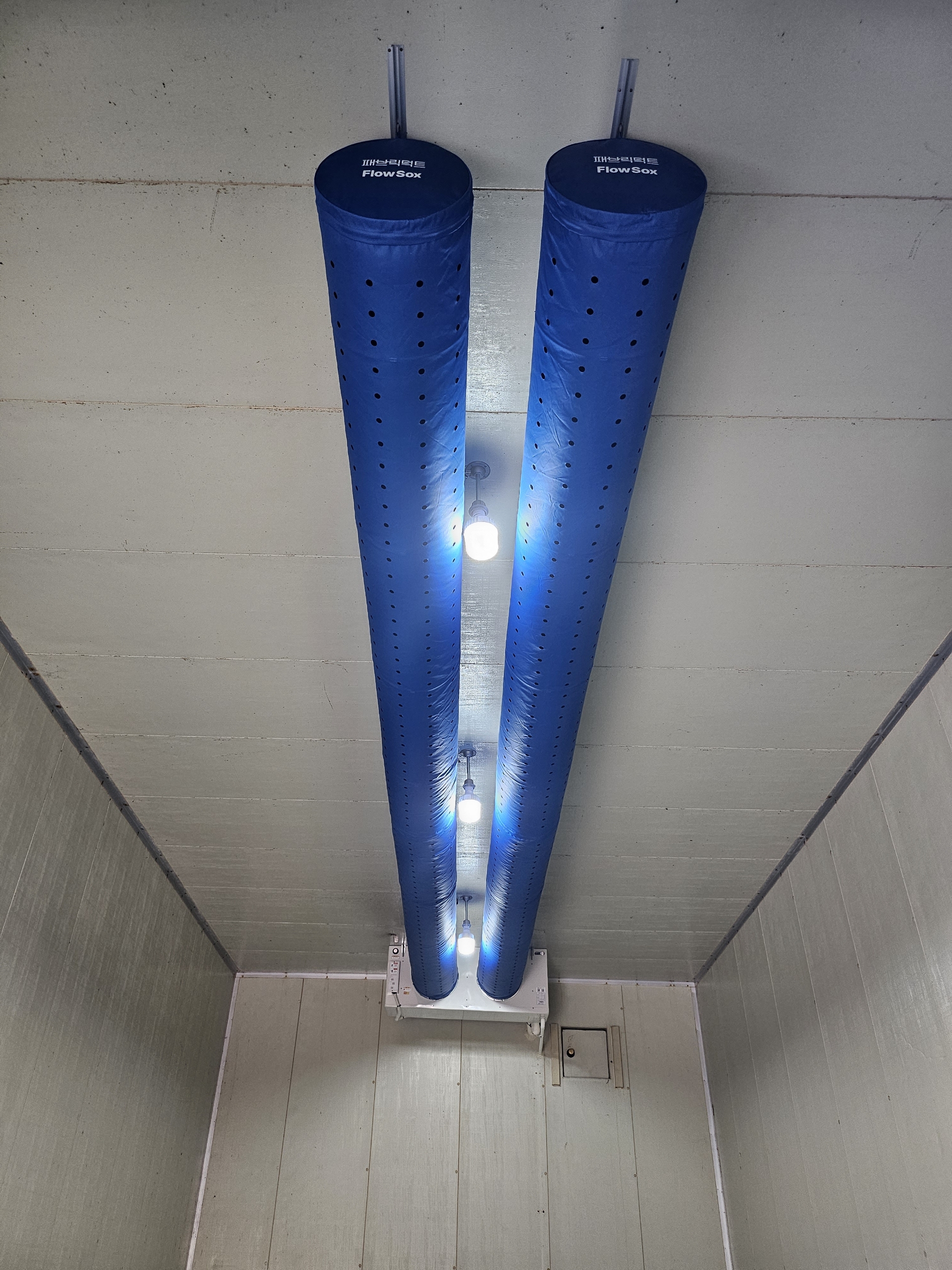 Blue FlowSox fabric ducts with micro-perforations