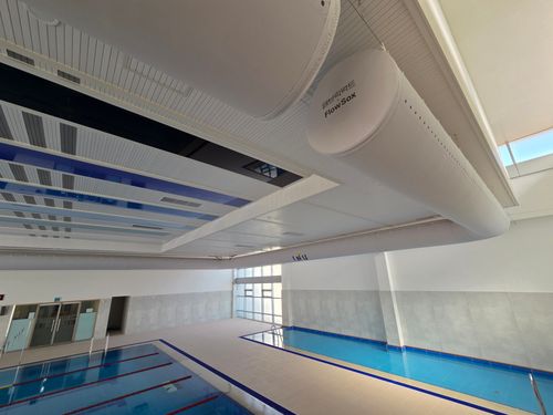 Fabric duct installation in a sports hall swimming pool